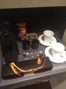 a table with a book and cups and utensils at Spa inspired guest suite in Jasper