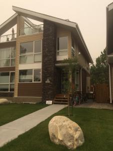 a house with a rock in front of it at Spa inspired guest suite in Jasper