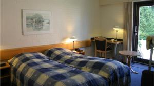 מיטה או מיטות בחדר ב-Hovborg Kro