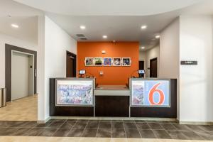 a lobby of a hospital with an orange wall at Motel 6-Las Vegas, NV - Motor Speedway in Las Vegas