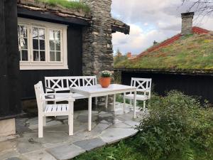 a white table and two chairs on a patio at Svenskveien 23b in Røros