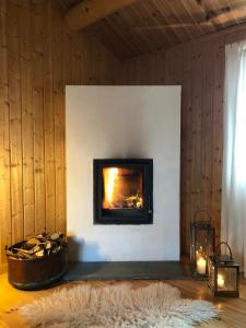 a fireplace in a room with a furry rug and a fire place at Svenskveien 23b in Røros