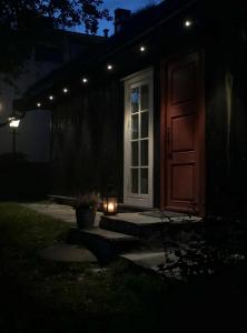 a door with a candle in front of a house at night at Svenskveien 23b in Røros