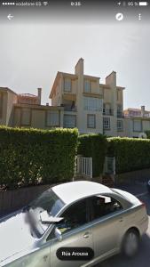 a silver car parked in front of a building at La Toja. Urb. Rueiros. in Isla de la Toja