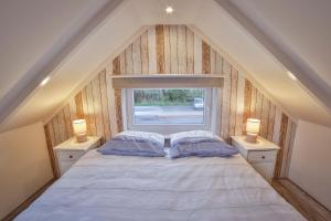 Ένα ή περισσότερα κρεβάτια σε δωμάτιο στο Het hoekhuisje