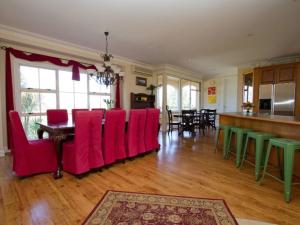 a living room with red chairs and a table at Rua Resort in Hamilton