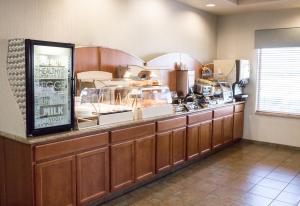 a restaurant kitchen with a counter with a food at Wingate by Wyndham Moses Lake in Moses Lake