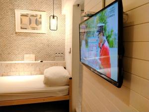 a tv hanging on a wall in a room at King Wow Inn in Tainan