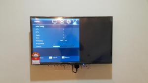 a flat screen tv hanging on a wall at Lotus Hotel Johor Bahru in Johor Bahru