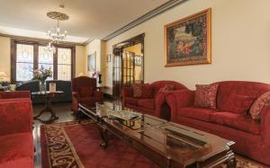 a living room with red couches and a table at Palais Royale in Katoomba