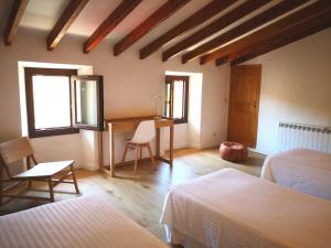 a bedroom with a desk and a table with chairs at Manyolas 93 in Alaró