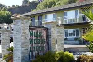 a house with a sign that reads mule wolves welcome in the lodge at Muir Woods Lodge in Mill Valley