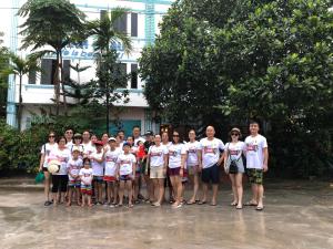 a group of people posing for a picture at Minh Chau Beach Resort in Quang Ninh