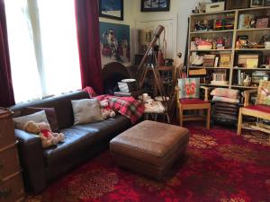 a living room with a couch and a stool at Laurel Bank House in Queenstown