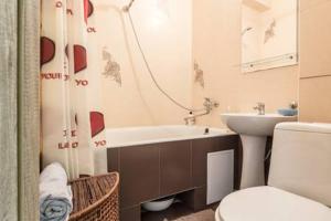 a bathroom with a tub and a sink and a toilet at Comfortable Apartment on the River Bank in Kyiv +34 photos