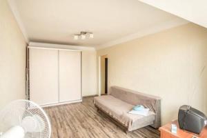 a living room with a couch and a tv at Comfortable Apartment on the River Bank in Kyiv