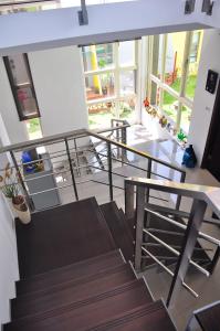 a room with stairs and a table and windows at HI One One in Magong
