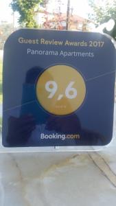 a sign for a guest review awaits panoramic apartments at Panorama Apartments in Paralía Skotínis