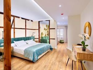 Postel nebo postele na pokoji v ubytování Hotel Boutique ADOLFO
