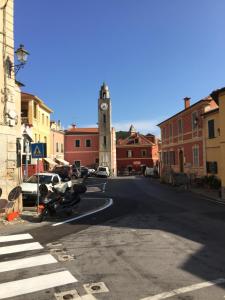 a city street with a clock tower in the distance at Cà Bartolomeo in Finale Ligure