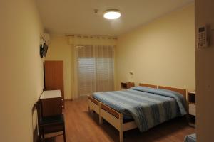 Postel nebo postele na pokoji v ubytování Hotel Cecco