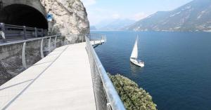 a boat in the water next to a tunnel at Appartamento BeB Preone CIR17089BEB01 in Limone sul Garda