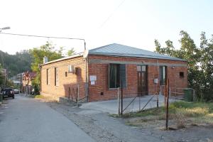 a small brick building on the side of a road at Maya Guest House in Sighnaghi
