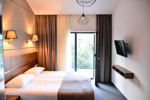 Postel nebo postele na pokoji v ubytování Hotel Garnet Tbilisi + 37 fotografií