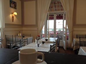 a restaurant with a table with a cup of coffee at Hotel Bellevue in Hendaye +32 photos