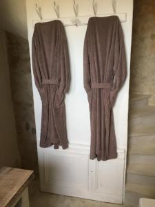 two towels are hanging on a wall in a bathroom at Domaine Sainte Suzanne in Puimisson