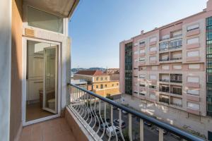 a balcony with a view of two buildings at LovelyStay - 2 Bedroom Belem Wonder in Lisbon