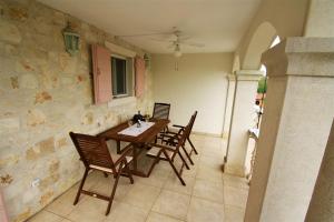 a dining room with a wooden table and chairs at Apartment Marija Kaštelir in Kaštelir