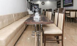 a bar with a long table and chairs at Treebo Trend JD Residency Mohali in Chandīgarh