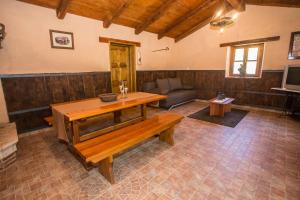 a living room with a table and a couch at Holiday House Legovic in Nova Vas