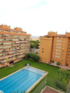 an overhead view of a swimming pool in front of buildings at Apartamento in Santa Susanna