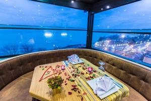 a table in a restaurant with a view of a city at Sinema Hotel Ordu in Ordu