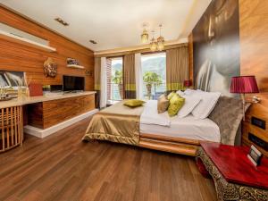 a bedroom with a large bed and a television at Hotel Forza Mare in Kotor