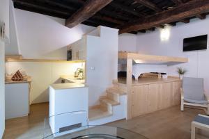 a kitchen with a spiral staircase in a room at San Clemente Holiday House in Bracciano
