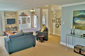a living room with two couches and a tv at Val d'Or Estate in Franschhoek
