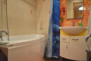 a bathroom with a tub and a sink and a shower at 12 Koidu in Narva-Jõesuu