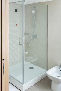 a shower with a glass door in a bathroom at Korona, Resort & Entertainment in Kranjska Gora