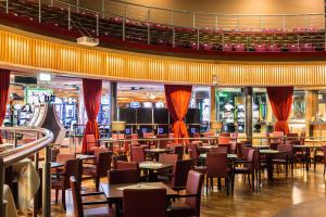 a dining area with tables and chairs in a restaurant at Korona, Resort & Entertainment in Kranjska Gora