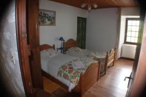 a bedroom with two twin beds and a window at les écureuils in Saint-Priest +25 photos