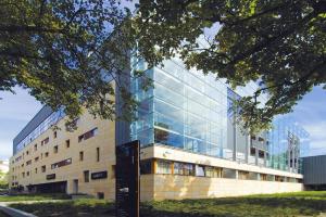 a building with glass windows on the side of it at Apartament w Hotelu Sand in Kołobrzeg