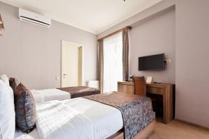 Ένα ή περισσότερα κρεβάτια σε δωμάτιο στο Hotel Pushkin