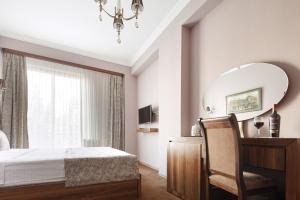 Ένα ή περισσότερα κρεβάτια σε δωμάτιο στο Hotel Pushkin