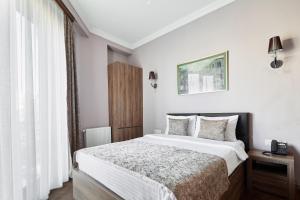 Ένα ή περισσότερα κρεβάτια σε δωμάτιο στο Hotel Pushkin