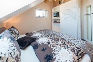 1 dormitorio con cama con edredón y almohadas en Komfort-Ferienwohnungen Horster, en Bensheim
