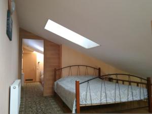 a bedroom with a bed and a skylight at Kotedzas Melnrageje in Klaipėda