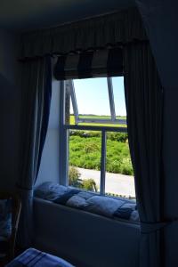 a window in a room with a window seat with a view at Chyheira in Ruan Minor